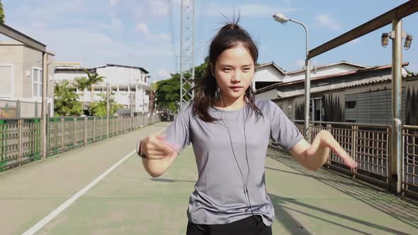 Athlete young Asian woman stretching legs and warming before running.