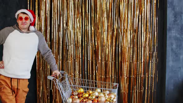 Man Carries Shopping Trolley with Christmas Toys