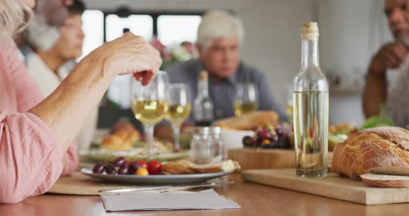 Portrait of happy senior diverse people having dinner at retirement home