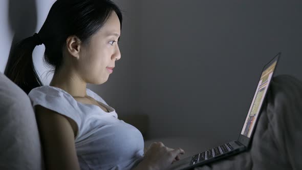 Woman use of laptop computer on bed