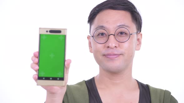 Face of Happy Japanese Man with Eyeglasses Showing Phone