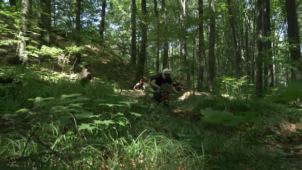 Mountain bikers jumping in the woods