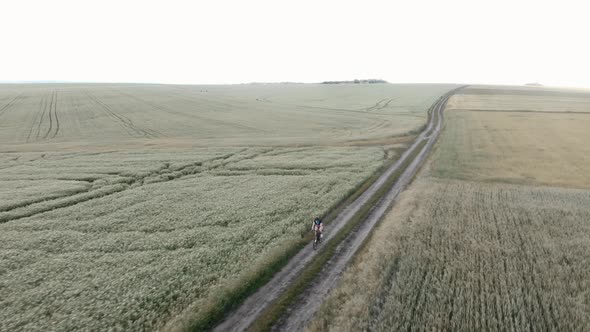 Cyclist cycling on gravel bicycle on trail road.