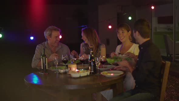 Friends having dinner together outdoors