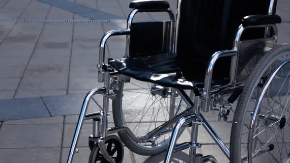 Invalid Wheelchair Rolling Near Modern Building