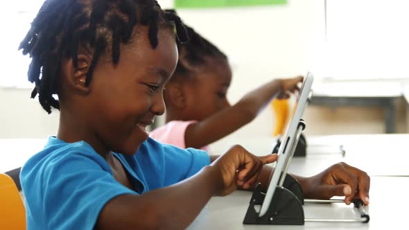 Boy using digital tablet in classroom