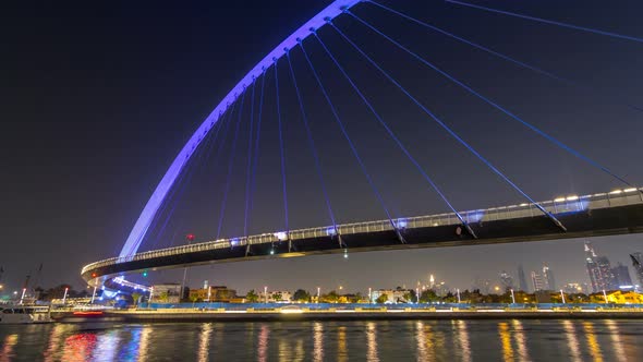 Futuristic Pedestrian Bridge Over the Dubai Water Canal Illuminated at Night Timelapse Hyperlapse