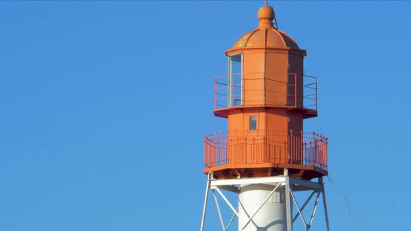 View to the top of the Pape beach lighthouse in sunny winter day, medium closeup shot, slow zoom in