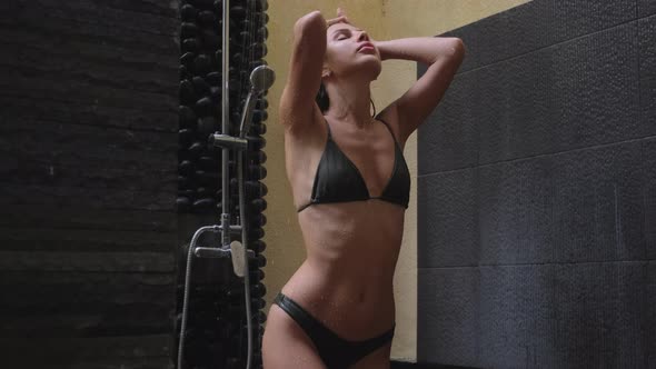Sexy Woman in Bikini in Spa Shower