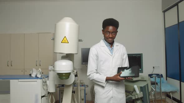 Close Up Portrait of Young African American Man Doctor in White Uniform and