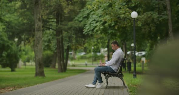 Typing On Laptop In The Park