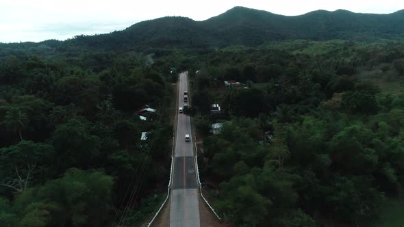 Aerial View of Countryside Road Passing Through the Lush Greenery and Foliage Tropical Rain Forest