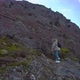Woman Hiker with Backpack and Her Dog Walking on Hill Slope - VideoHive Item for Sale