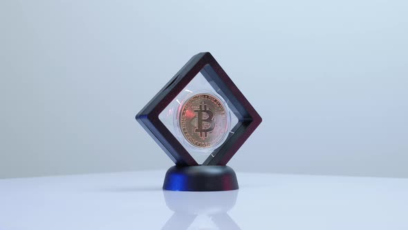 Shiny golden bitcoin rotating and reflecting light
