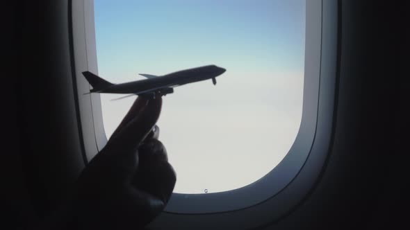 Woman with plane model against illuminator