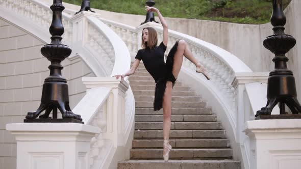 Slow Motion of a Young Blonde Girl in Tutu Standing on a Beautiful White Stairs Outside on the