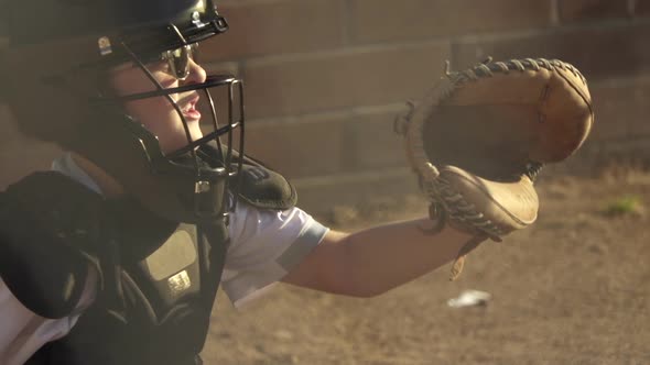 A boy plays catcher in a little league baseball game.