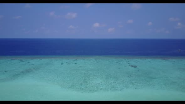 Aerial above landscape of paradise seashore beach lifestyle by blue green sea and white sand backgro