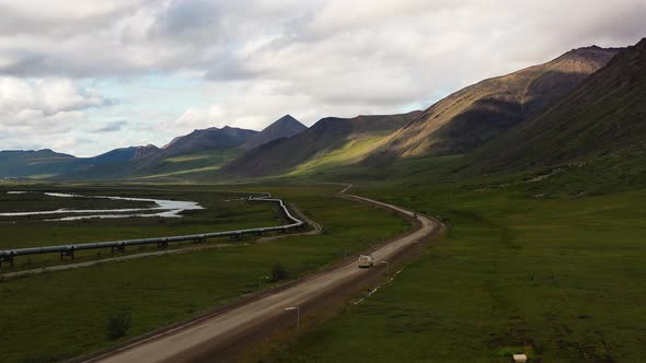 Van driving on Portage Glacier road throw the Portage valley along Trans Alaska crude oil Pipeline b