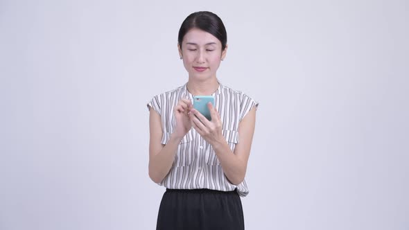 Happy Beautiful Asian Businesswoman Thinking While Using Phone