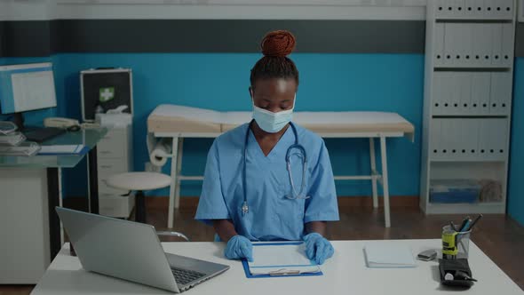 Portrait of Medical Nurse Looking at Camera with Face Mask