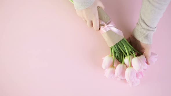 Bouquet of pink tulips on a pink background.