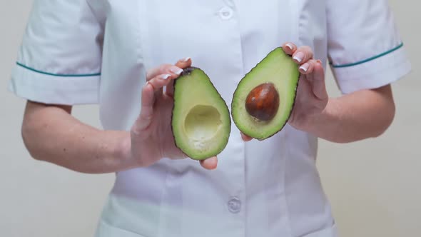 Nutritionist Doctor Healthy Lifestyle Concept - Holding Organic Avocado