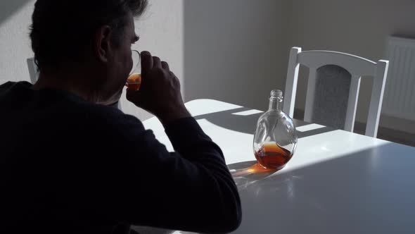 Rear View of Man Sipping Alcohol From Glass