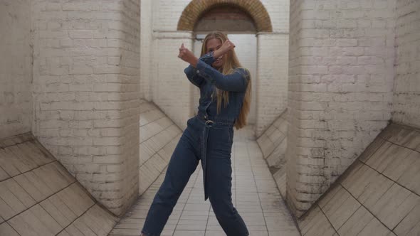 Blond Girl In Jumpsuit Dancing In Tunnel