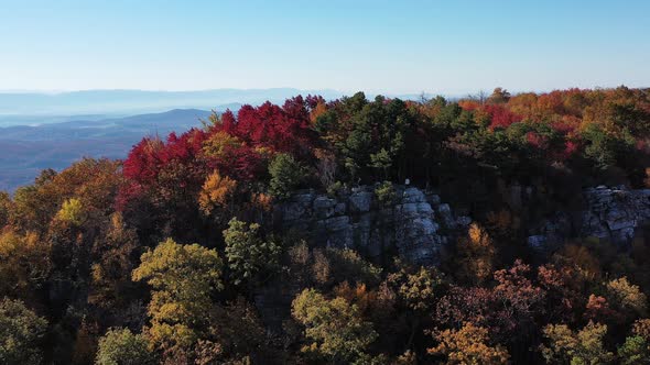 An aerial shot of a man standing on Tibbet Knob, part of Great North Mountain, the border between Vi