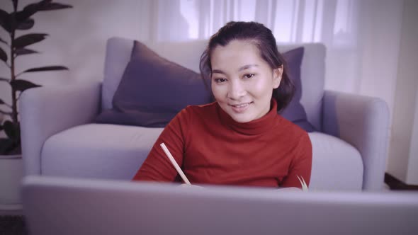 Businesswoman on redshirt using the laptop for meeting online and work from home in coronavirus