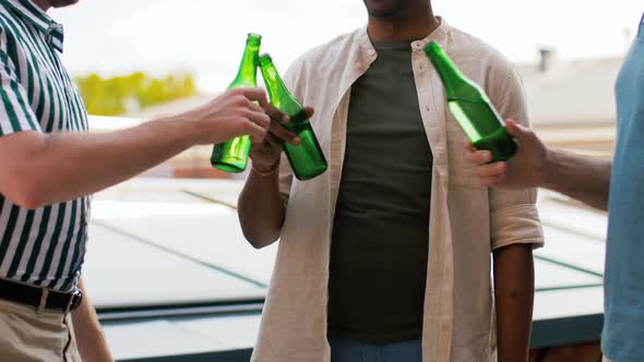 Happy Male Friends Drinking Beer at Rooftop Party