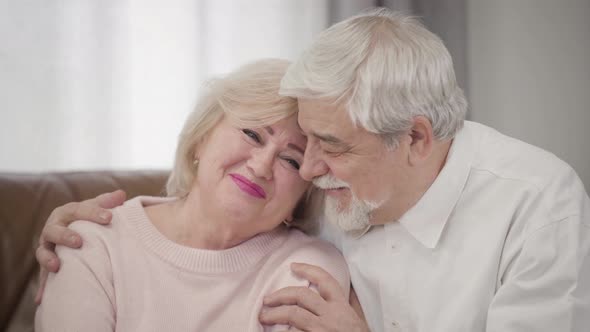 Portrait of Smiling Elderly Caucasian Spouses Looking at Camera. Joyful Mature Husband and Wife