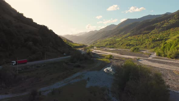 Rising View Over Valley With Passing Truck In K Azbegi National Park