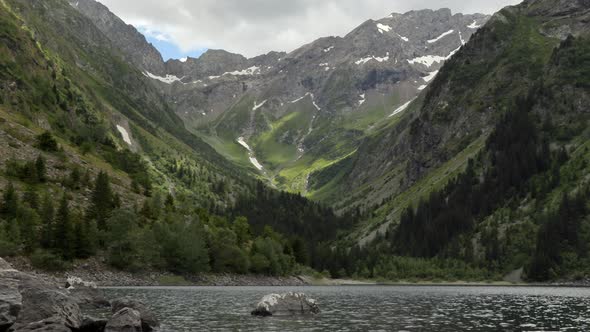 Smooth zoom in from a wide angle view of Lauvitel lake to the detail of the perma snow from the glac