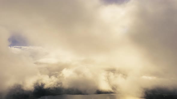 Time lapse aerial view up from the clouds to the sky in motion. 