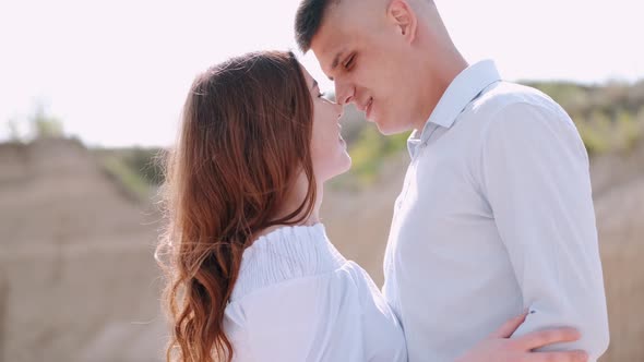 Portrait of Man and Woman in Light Blue Clothes Kissing