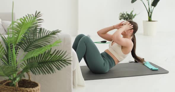 Athletic Brunette Woman is Having Abdominal Press Exercises