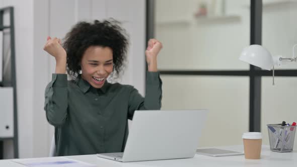 Successful African Woman Celebrating Laptop