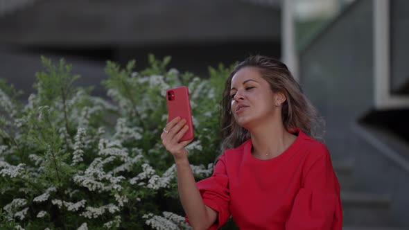 Woman is Streaming in Social Network or Communicating By Online Video Chat Using Modern Gadget