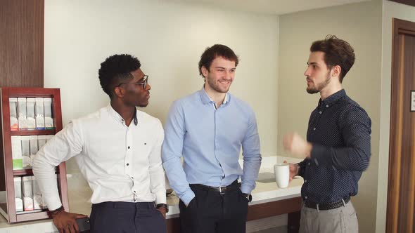 Three Awesome Office Workers Having Fun During the Coffee Break