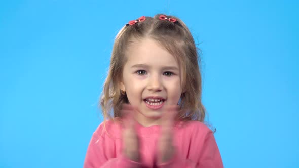 Child Is Telling Something and Clapping Her Hands, Blue Background