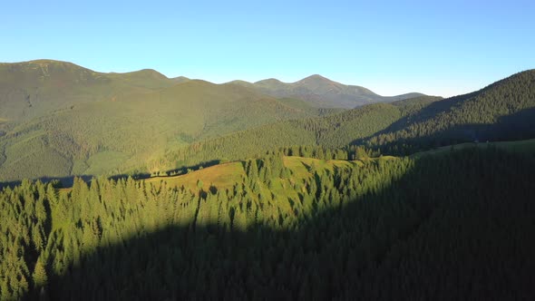 Majestic mountain valley on a sunny day with green alpine meadows.