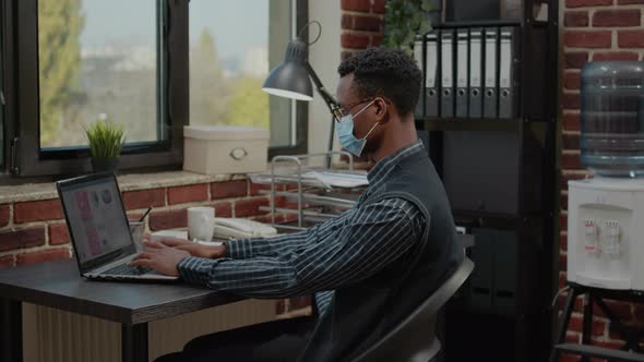 Portrait of Business Man Wearing Face Mask in Startup Office