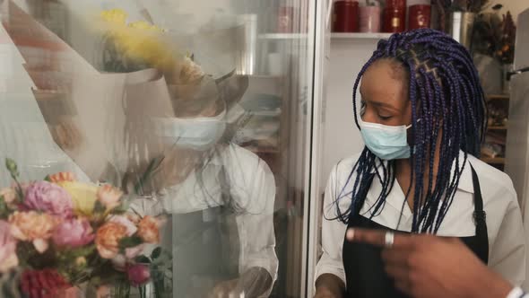 Florist and Male Customer Choosing Flower Bouquet at Store