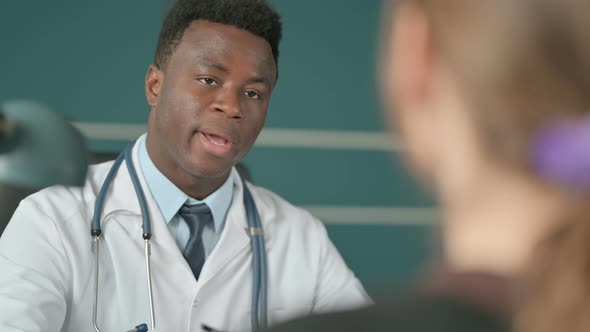 African Doctor Doing Consultation with Patient in Office