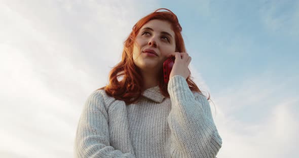 Young Girl Talks on the Phone with Her Mom in the Nature