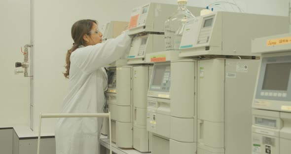 Scientist working with mass spectrometer in a pharmaceutical laboratory conducting experiments