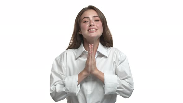 Closeup of Attractive Caucasian Woman Begging for Favour Saying Please and Holding Hands in Pray