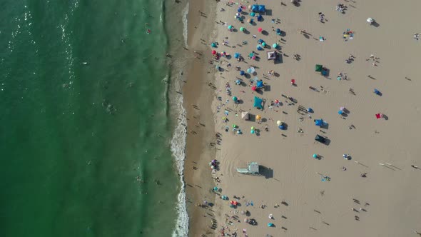 Tourists Leisurely Swimming, Relaxing And Sunbathing In The Beach At Summer. - aerial